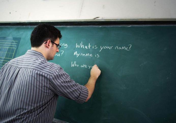 Overseas Talents-Teacher writing on blackboard